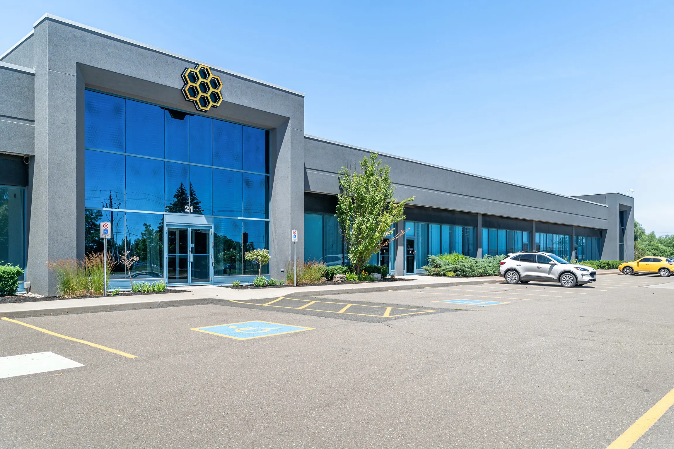 Photo of Regency Business Park Oakville's glazed entrance and grey facade.