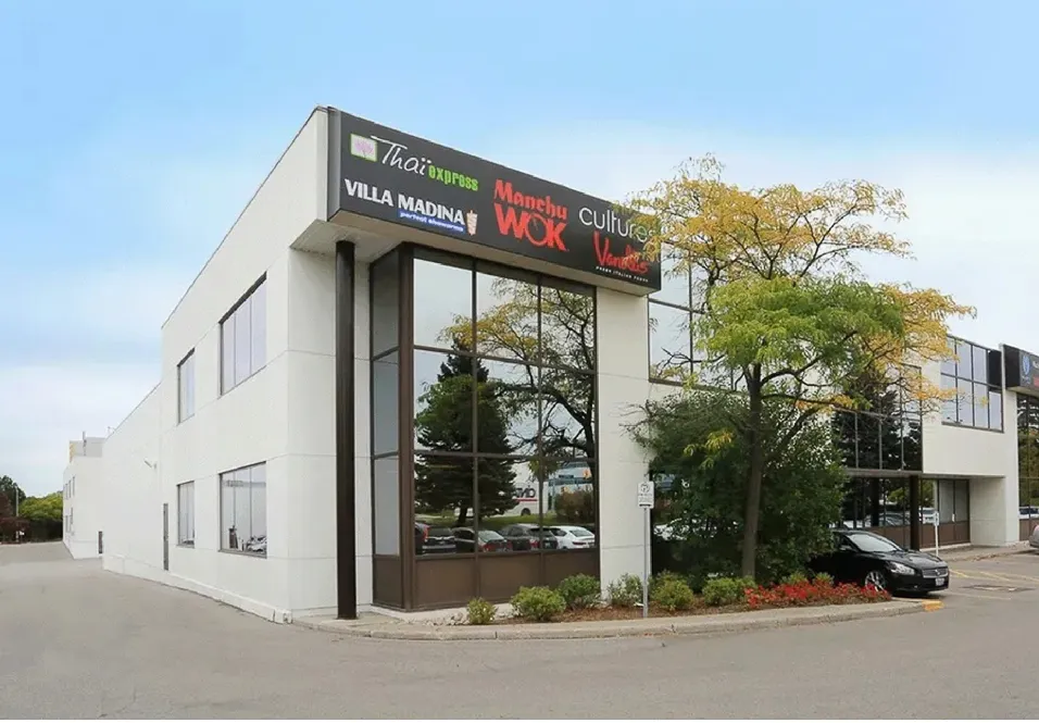 Photo of a two-storey East Beaver Creek building with tenant signs on its corner.